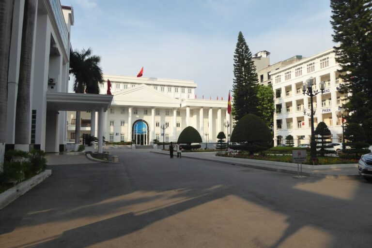 A view of buildings with trees and a road.