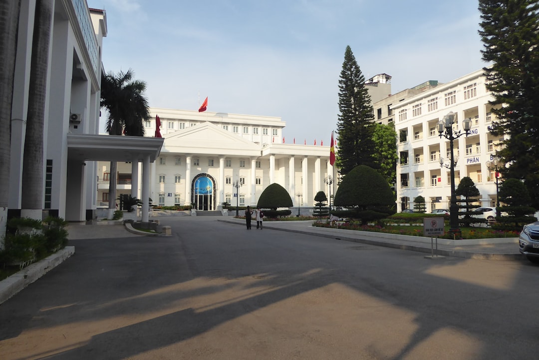A view of buildings with trees and a road.