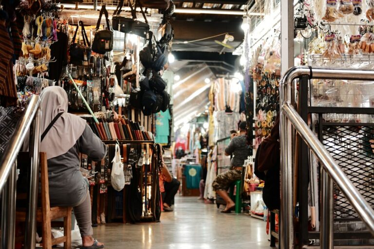 a woman is walking up a set of stairs in a store