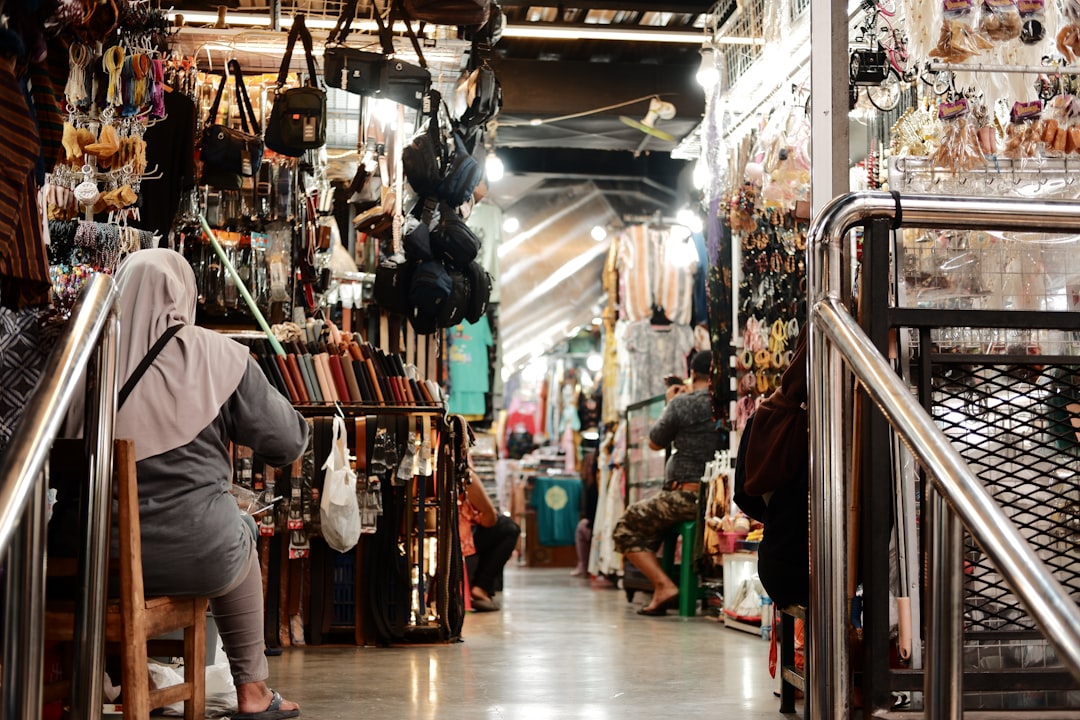 a woman is walking up a set of stairs in a store