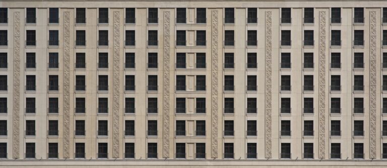 a tall building with many windows and a clock