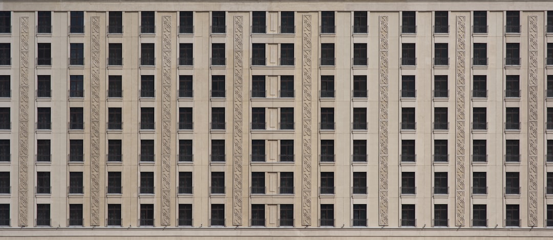 a tall building with many windows and a clock