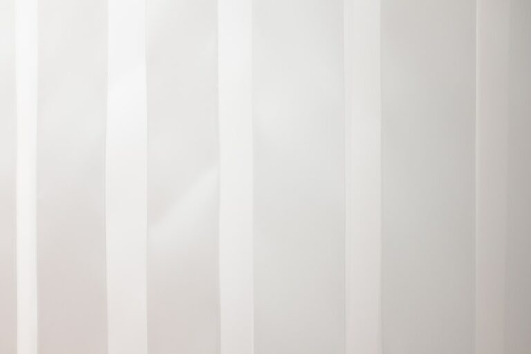 a white wall with vertical lines painted on it
