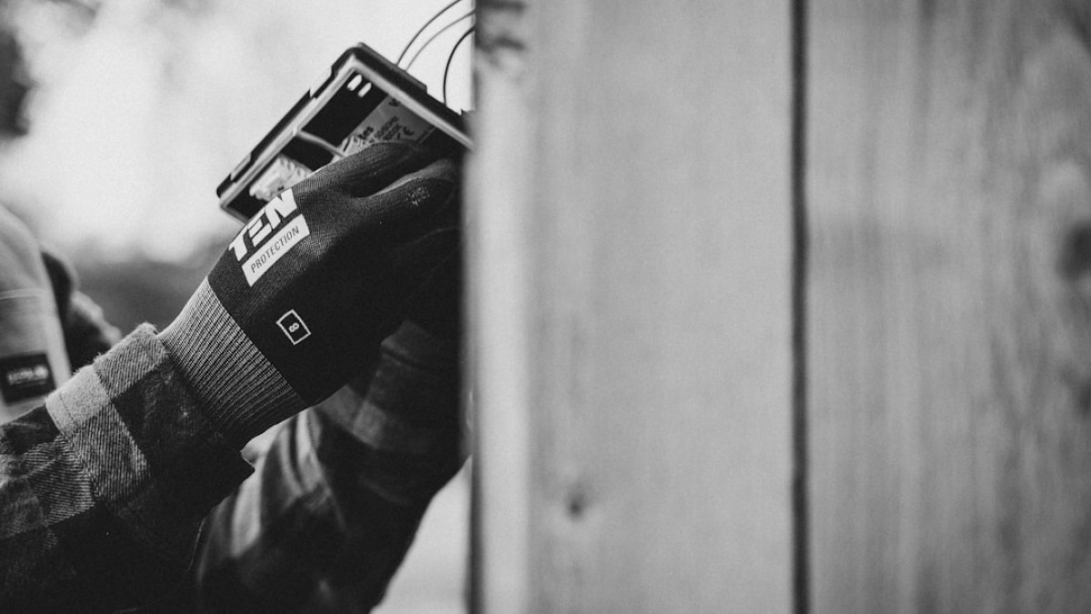 a black and white photo of a person holding a cell phone