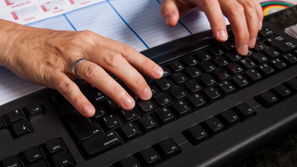 a pair of hands on a keyboard