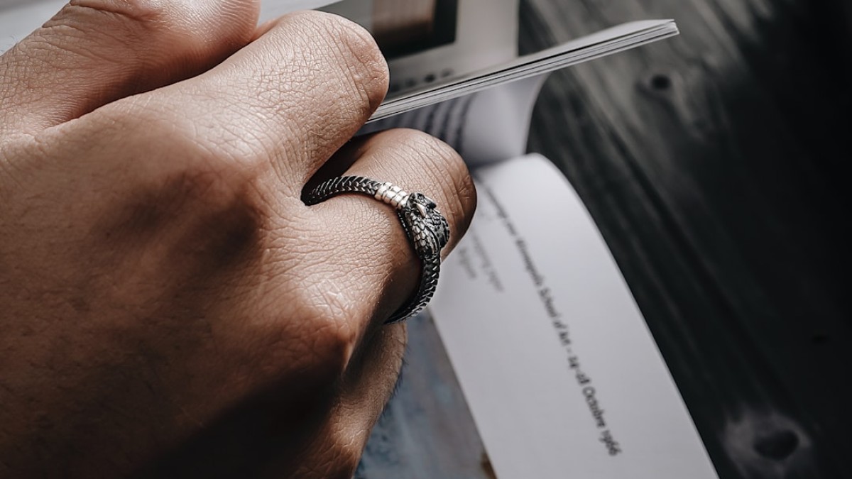a person holding a knife with a ring on it