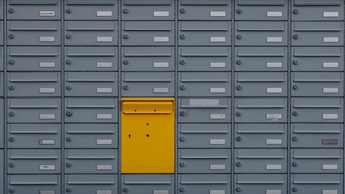 a bunch of mail boxes with a yellow door